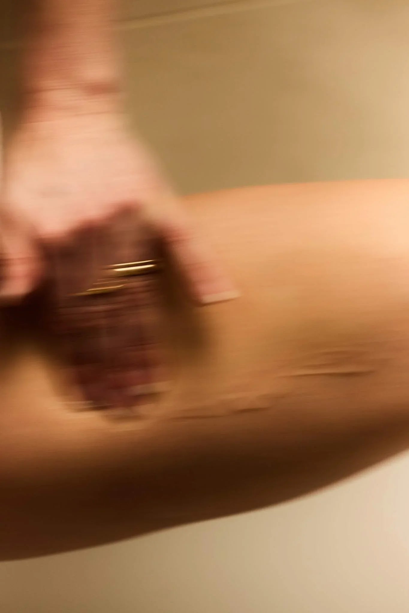 Person applying Nectar Intimate serum on inner thigh.